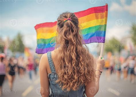 Woman Proudly Displaying A Rainbow Flag Symbolizing Lgbt Pride And Equality At A Vibrant Gay