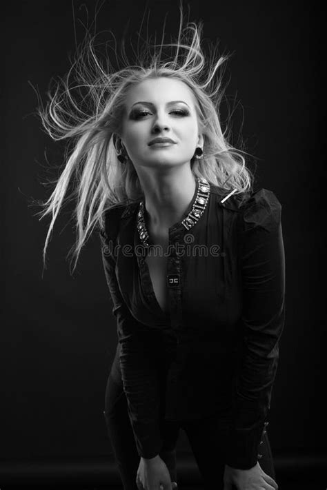 Attractive Blond Woman With Bright Makeup And Long Hair Wears Jacket On A Naked Body Stock Photo