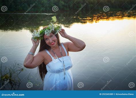 Adult Mature Brunette Woman In A White Dress Sundress And A Wreath Of