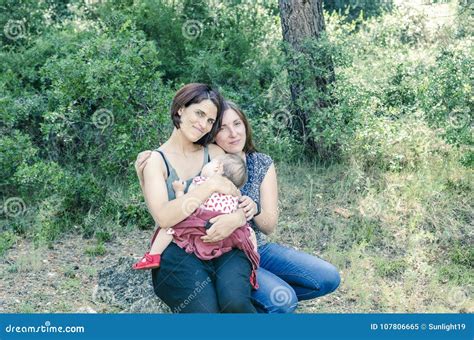 Adorable Lesbian Couple With Their Baby Girl In Nature Stock Image Image Of Artificial