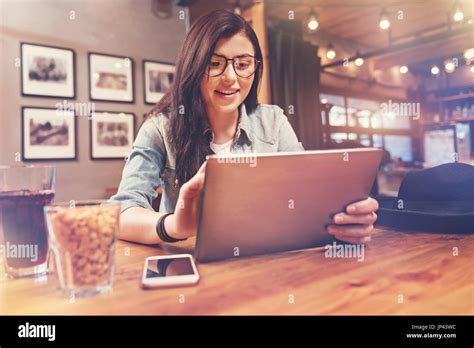 Positive Delighted Brunette Holding Her Tablet Stock Photo Alamy