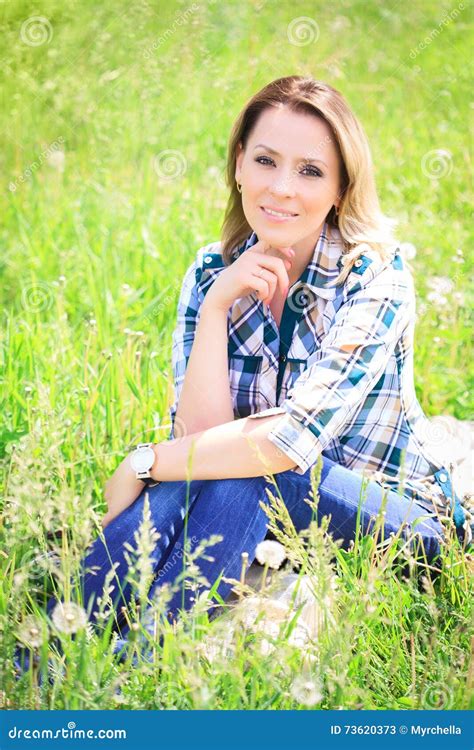 Portrait Of A Beautiful Attractive Woman In The Grass Stock Image