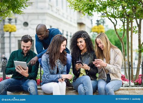 Multi-ethnic Young People Using Smartphone and Tablet Computers Stock Photo - Image of mixed ...