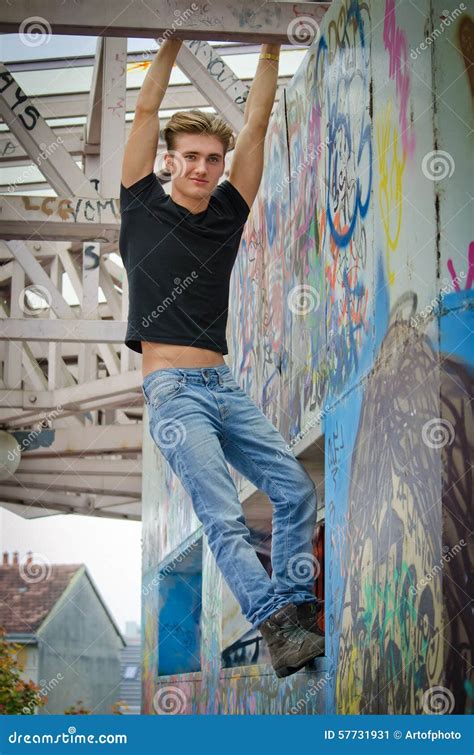 Het Knappe Blonde Jonge Mens Hangen Van Betonconstructie Stock Afbeelding Image Of Levensstijl