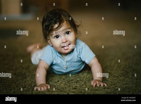 Happy Baby Crawl On Stomach In His Home And Smiles Stock Photo Alamy