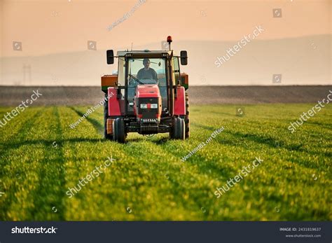 Young Farmer Tractor Fertilizing Crops Green Stock Photo 2431819637