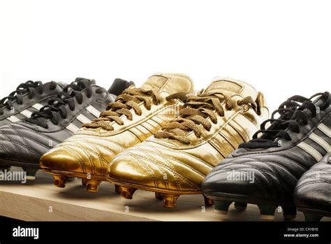 Row Of Black And Gold Football Boots Stock Photo Alamy