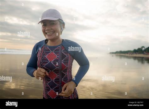 Fit And Attractive Mature Woman With Grey Hair Doing Beach Workout On Her S Running On The