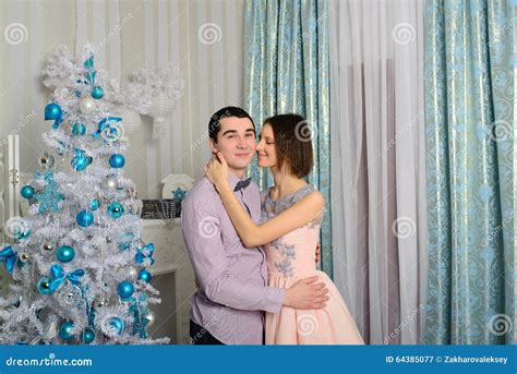 Nice Love Couple Sitting On Carpet In Front Of Fireplace Stock Image