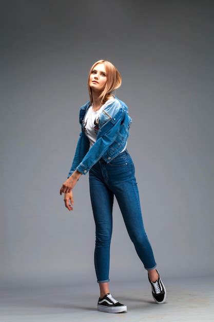 Premium Photo Beautiful Sexy Blonde Woman Dressed In A Denim Jacket And Blue Jeans Fashion