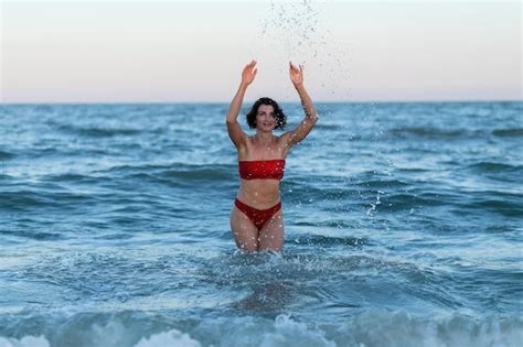 Premium Photo Sexy Back Of A Beautiful Woman In Red Bikini On Sea Background