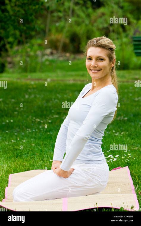 Blonde Girl In Nature Green Park Exercising Yoga Fitness Program Stock Photo Alamy