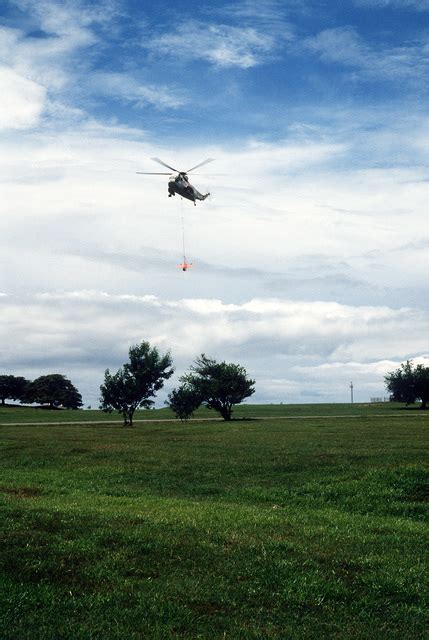 A Ground To Air View Of An SH 3 Sea King Helicopter Airlifting A