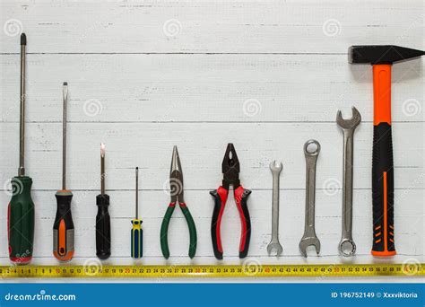 Assortment Of Different Construction Tools On White Wooden Background