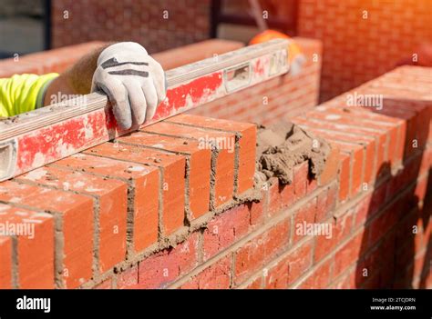 Bricklayers Laying Bricks On Mortar Stock Photo Alamy