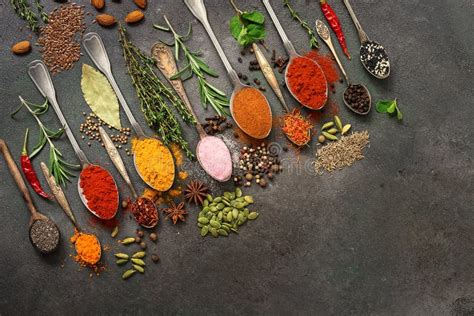 A Variety Of Spices Herbs Seeds In A Spoon On A Dark Painted Rustic