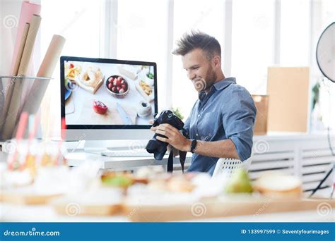 smiling photographer working  studio stock image image  male