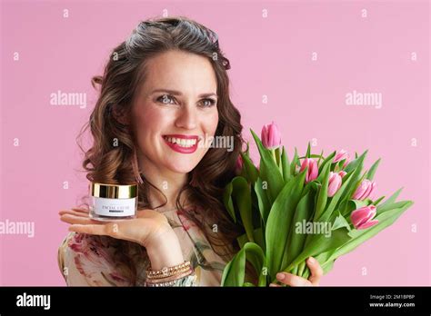 Smiling Modern 40 Years Old Woman With Long Wavy Brunette Hair With Tulips Bouquet And Cosmetic