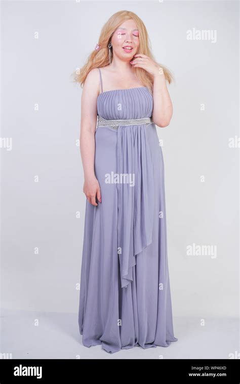 Cute Fashion Lady With Asian Face And Blonde Hair In Gray Dress Stock