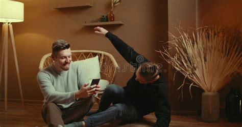 Cute Male Gay Couple Spend Time Sitting Chair Floor Use Smartphone Stock Video Video Of Loft