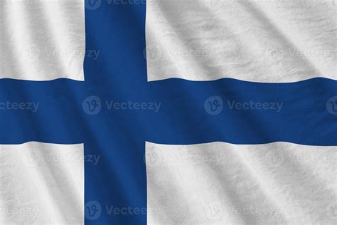 Finland flag with big folds waving close up under the studio light