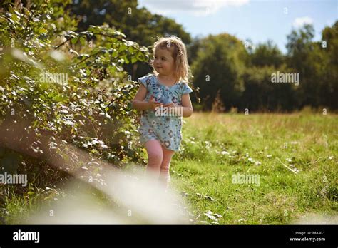 Young Girl Walking Through Field Stock Photo Alamy