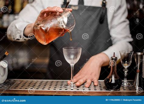 Bartender Pouring Fresh Alcoholic Drink Into The Cocktail Glass Stock Image Image Of Amber