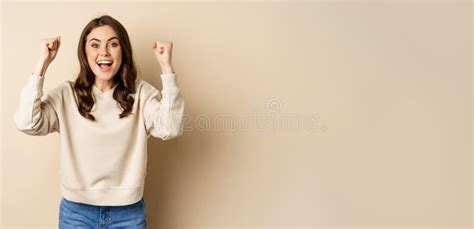 Enthusiastic Brunette Woman Laughing And Smiling Cheering Shaking Hands And Celebrating