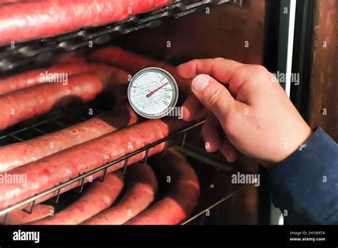 Checking the temperature of sausages to see if they are cooked Stock ...