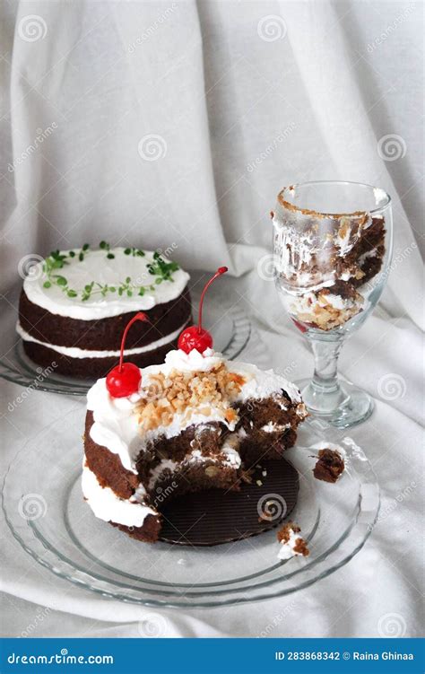 Chocolate Naked Cake With Cream Frosting And Decorated With Cherry Peanut And Thyme Stock Photo
