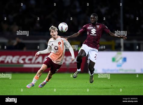 ali dembele  torino fc competes   ball  alexis saelemaekers