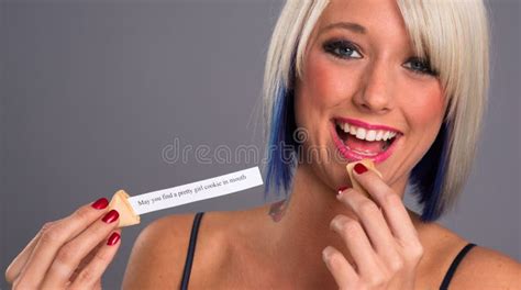 Pretty Blonde Woman Eats Fortune Cookie Showing Message Stock Photo Image Of Expression