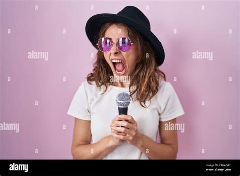 Beautiful Brunette Woman Singing Song Using Microphone Angry And Mad