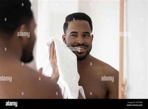 Mirror Reflection Smiling African American Man Wiping Face With Towel