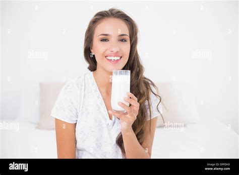 Smiling Pretty Brunette Holding Glass Of Milk Stock Photo Alamy