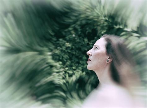 Premium Photo Mature Woman Looking Away While Standing Against Plants