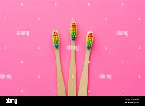 Photo Of Three Toothbrushes With Rainbow Colored Bristles Stock Photo