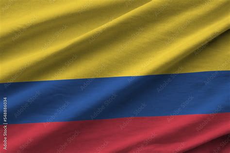 Colombia flag with big folds waving close up under the studio light ...