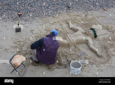 Man Sculpting A Jesus Christ Sculpture In Sand Stock Photo Alamy