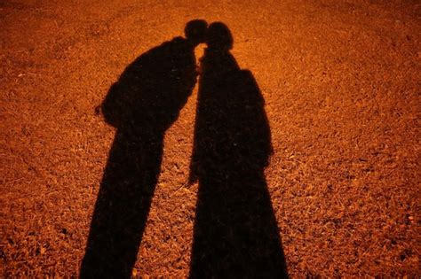 Premium Photo Shadow Of Couple Standing On Land