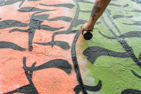 Unrecognizable Person Painting Graffiti On Wall · Free Stock Photo