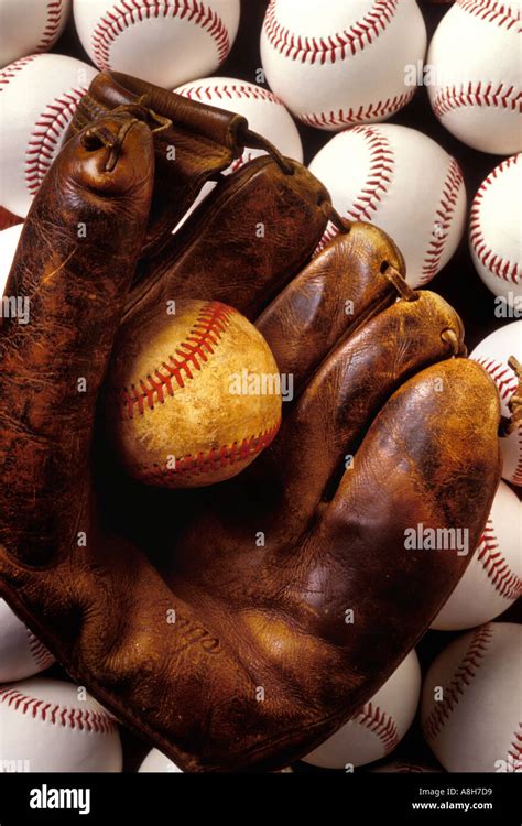 Old Child S Baseball Mitt Holding Old Worn Ball Laying Of Top Of Pile