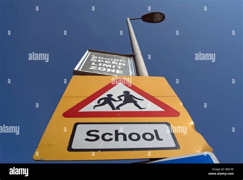 British Road Signs Indicating A School With Children Crossing The Road