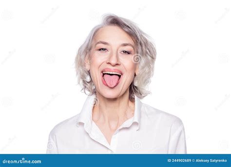 Shot Of A Beautiful Mature Woman Having Fun And Teasing Sticking Out Her Tongue Isolated On