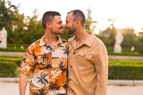 Premium Photo Romantic Portrait Of Gay Newlyweds Walking And Having Fun At Sunset In A Park In
