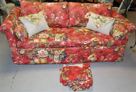 Floral print sleeper sofa with loads of accent pillows,