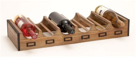 A Wooden Wine Rack With Four Bottles In It