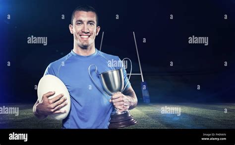 Composite Image Of Portrait Of Smiling Rugby Player Holding Trophy And