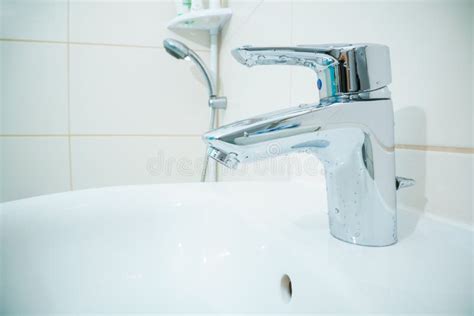 Chromed Metal Faucet For Hot And Cold Water In A Modern Bathroom Stock Photo Image Of Steel