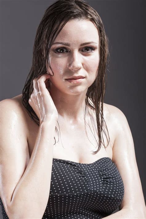 Portrait Of Caucasian Sensual Brunette Touching Neck And Showing Wet And Shining Skin And Wet
